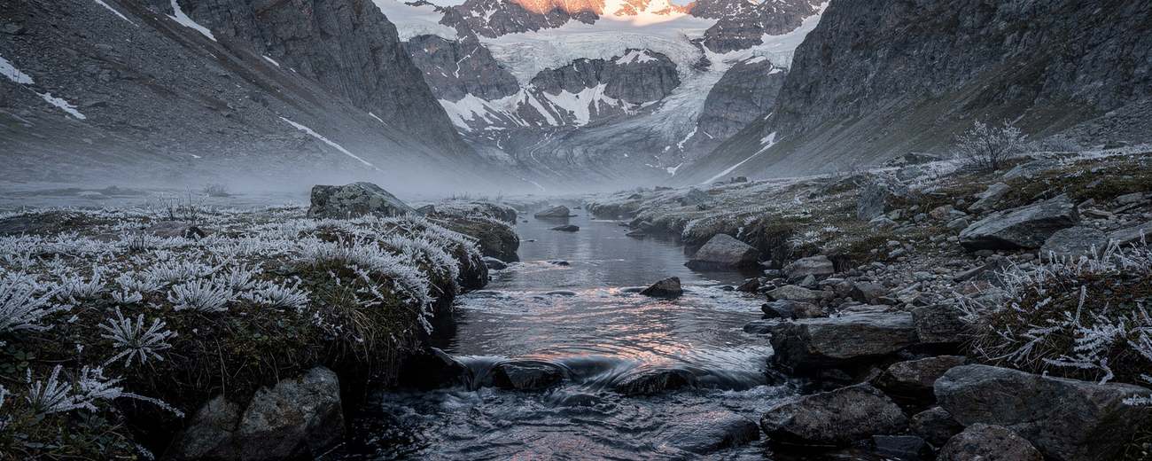 A headwater stream at first light, alpenglow on the peaks.
